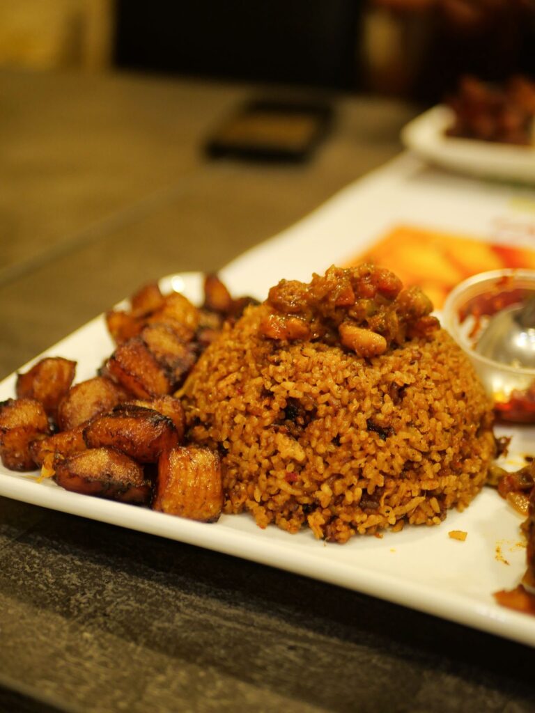 Jollof Rice mit gegrilltem Fisch, typisches Gericht in Ghana